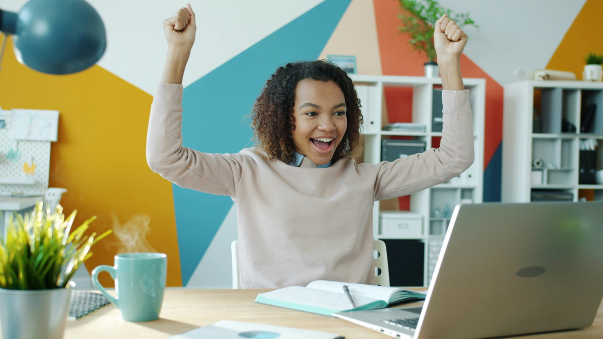 A business owner celebrating at her desk
